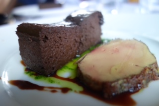 Fondant au canard et cabernet présenté dans une assiette avec du foie gras